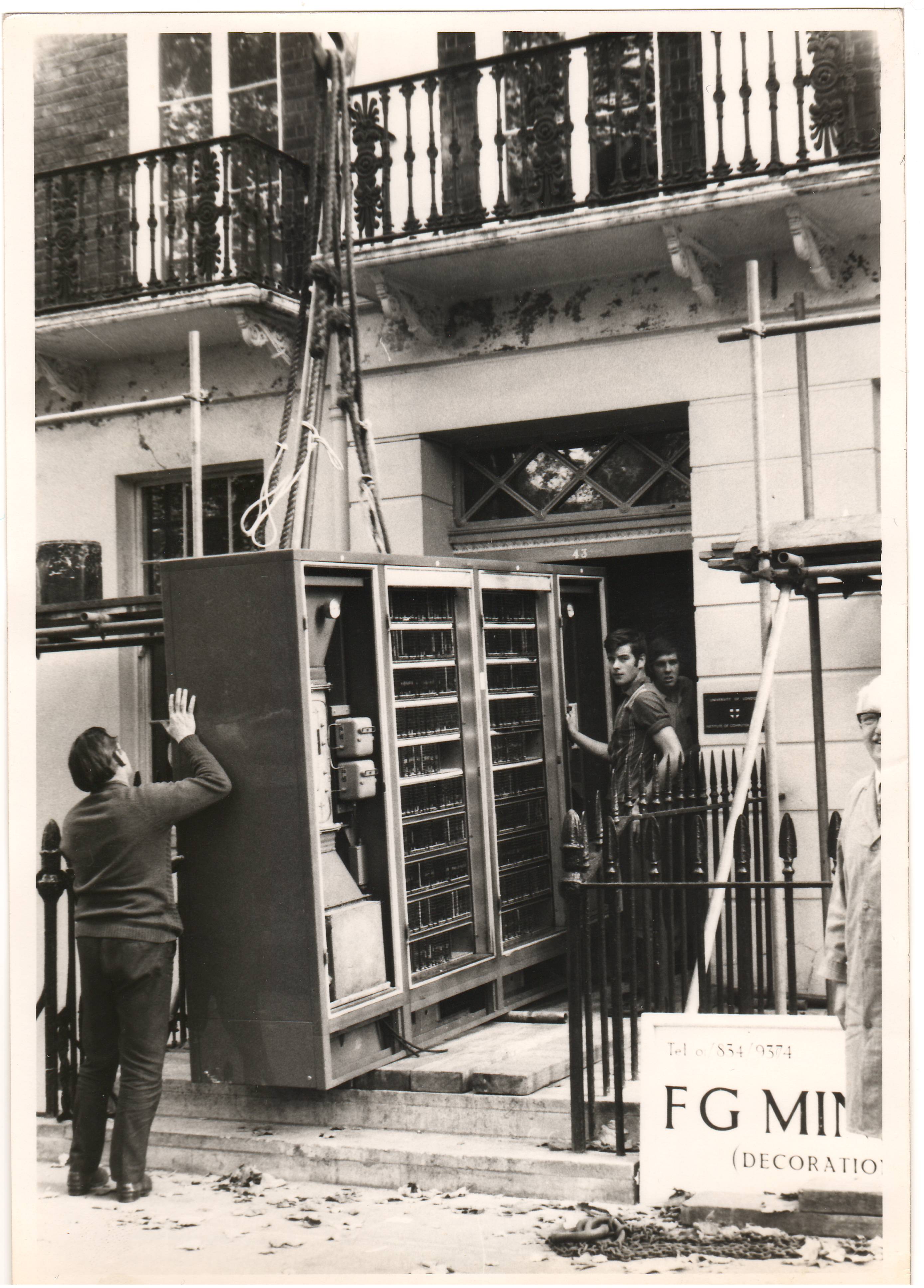 Fig 12: A view of one of the cabinets being taken through the front door. The building in which ATLAS was housed is scheduled as a building of historical interest and great care had to be taken not to damage the balcony or the fabric of the building.