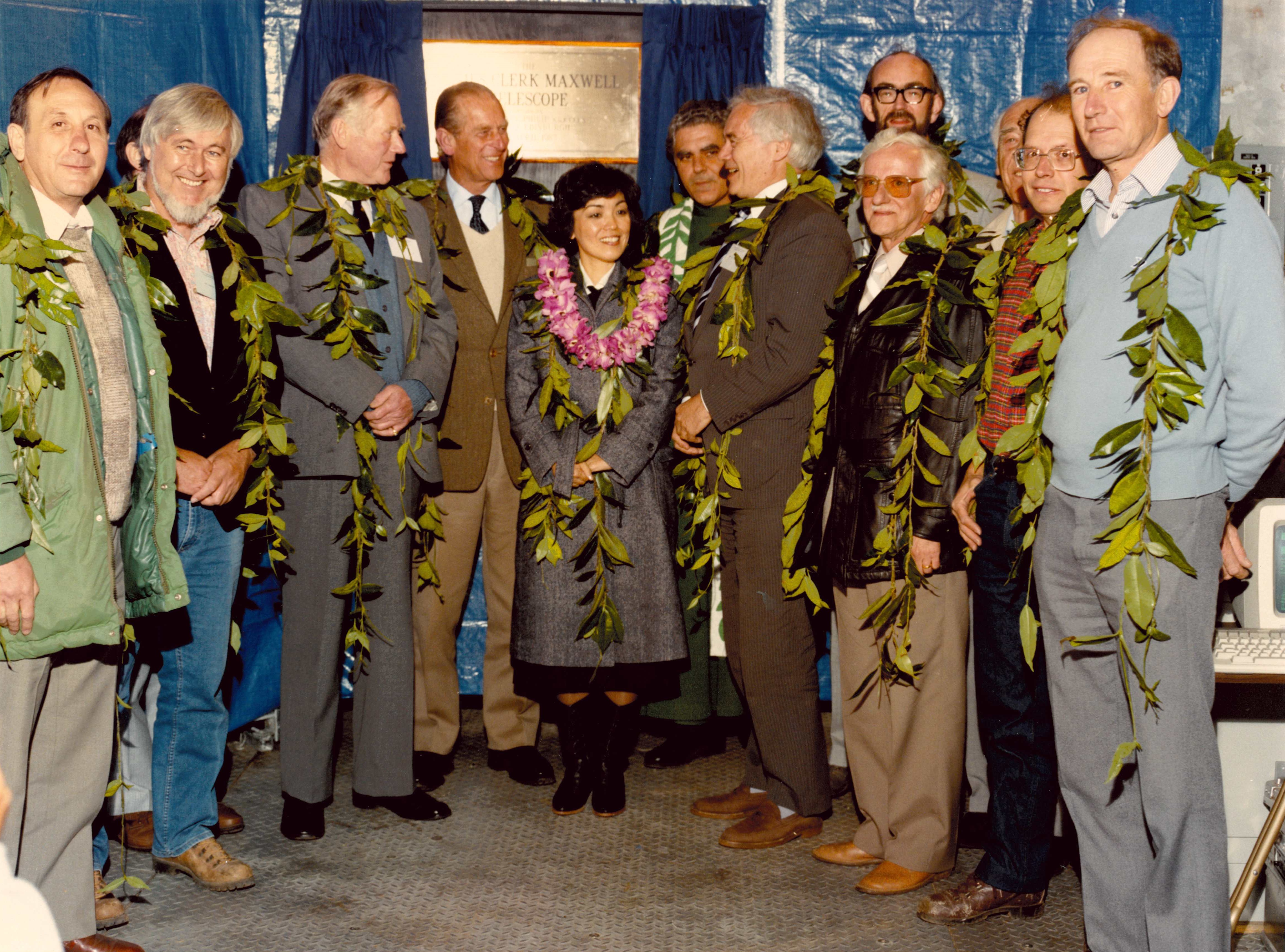 In the photo are:
Roy Tolcher (Head of Council Works Unit, SERC), Dr Don Hall (University of Hawaii), 
Sir John Clerk (descendant of James Clerk Maxwell), HRH Prince Philip, Duke of Edinburgh, 
Mrs Lynne Waihee (deputising for her husband, the Governor of Hawaii), Dante Carpenter (Mayor of Hawaii County), 
Professor Bill Mitchell (Chairman, SERC), Dr Bernard Gingras (NRC, Canada), Dr Paul Williams (Director of RAL), 
Dr Albert Mulder (ZWO, Netherlands), Professor Richard Hills (Project Scientist), Brian Edwards (Project Engineer).